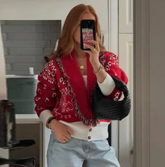 Styled look pairing a red statement cardigan with a fitted turtleneck and denim, creating an easy layered outfit for cooler days