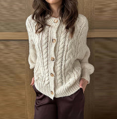 Outfit styling view showing the beige cardigan worn slightly slouched, with roomy sleeves and an easy drape over a minimal base layer.