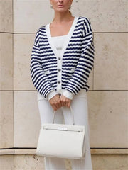 Striped cardigan styled on a boat for relaxed summer look