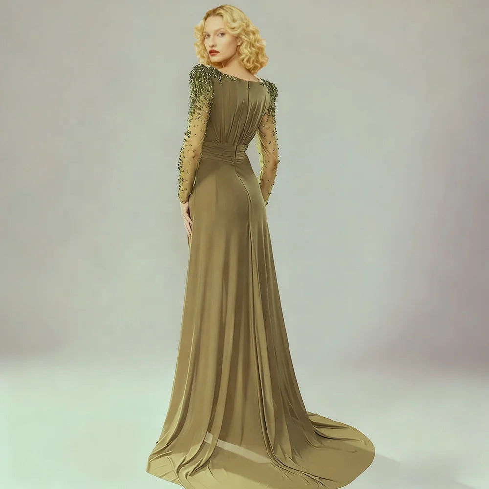 Floor-length formal gown with pleated draping and a sweeping finish