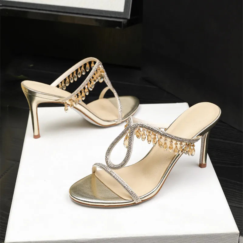 Close-up of rhinestone strap detailing and slight platform on high heel sandals, showing texture, shine, and clean edging.