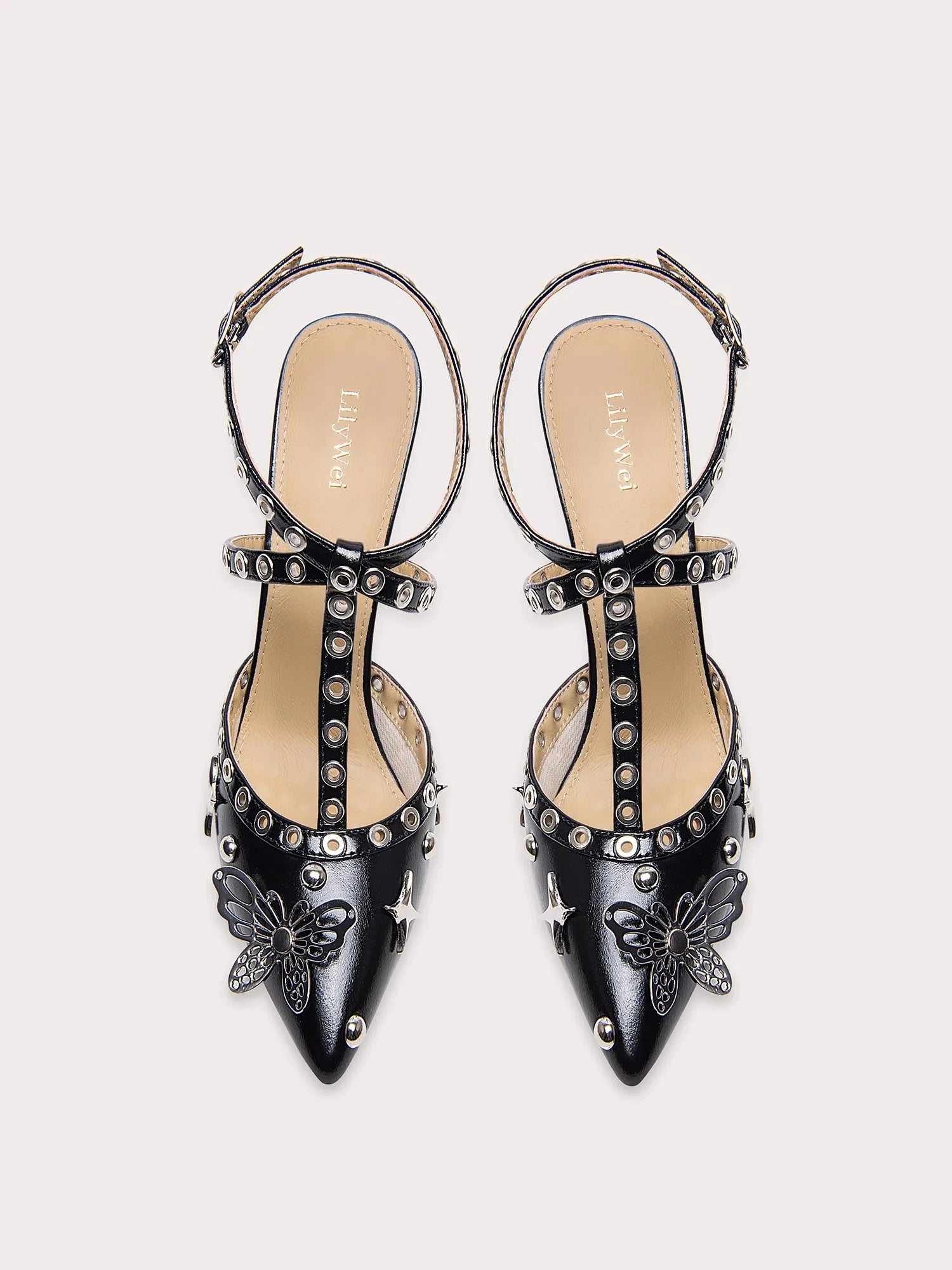 A close-up of the rivet and butterfly detail on the sandal.