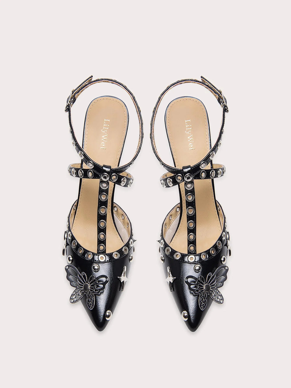 A close-up of the rivet and butterfly detail on the sandal.