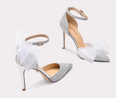 Pair of high-heeled shoes with sheer overlay on a white background