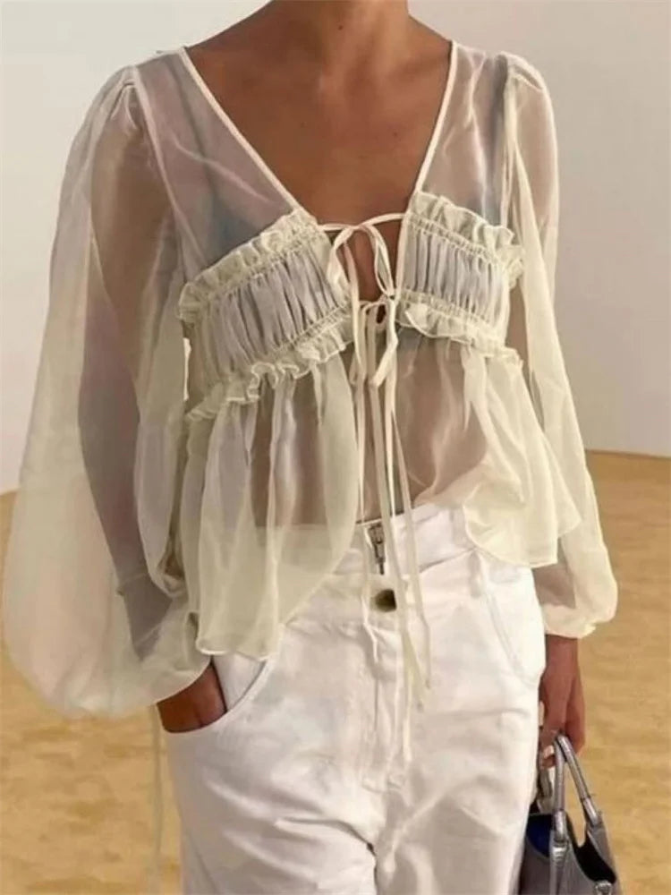 White chiffon blouse styled with pants for spring brunch look