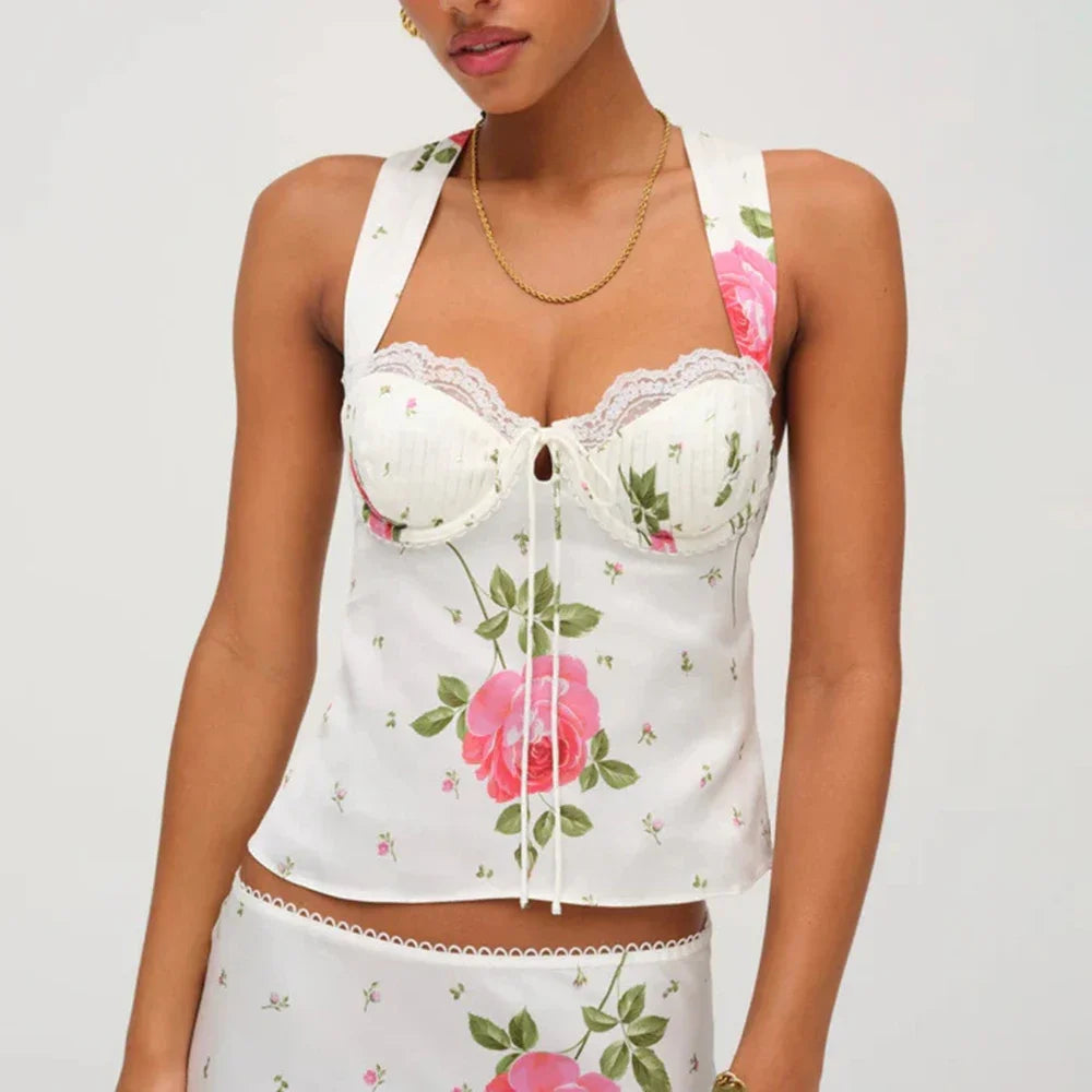 Woman wearing a white floral bustier top with rose print and square neckline on a white background