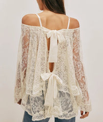 A full shot of the ruffled layered blouse, highlighting the bow-tied details.