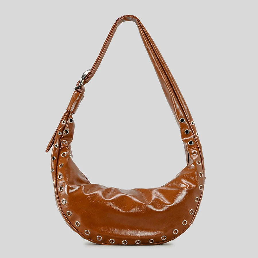 Runway inspired rivet bag in soft brown shown underarm
