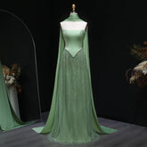 Sage green evening gown with square neckline and draped scarf on mannequin