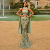 Sage green strapless mermaid evening gown with draped scarf detail on model