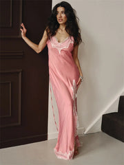 Woman wearing blush pink satin dress with lace trim for a formal summer occasion