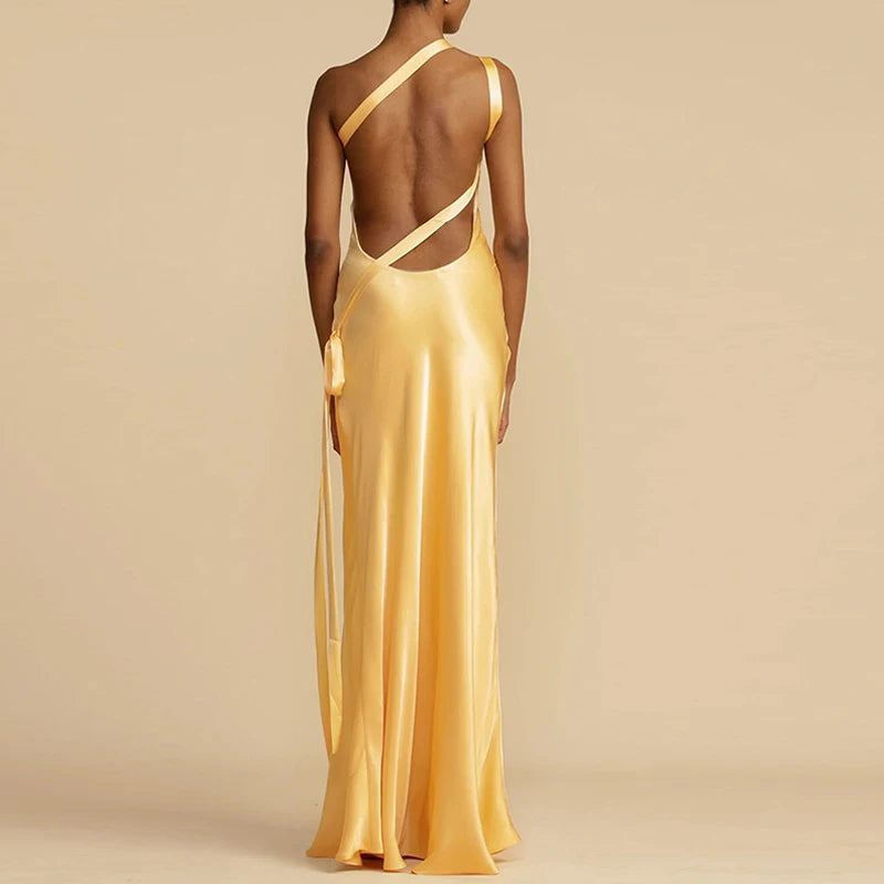 Backless design with cross straps on a satin one-shoulder formal gown