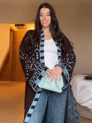 Front view highlighting the scarf collar and tie belt on a patterned knit cardigan, styled closed for a defined, polished silhouette.