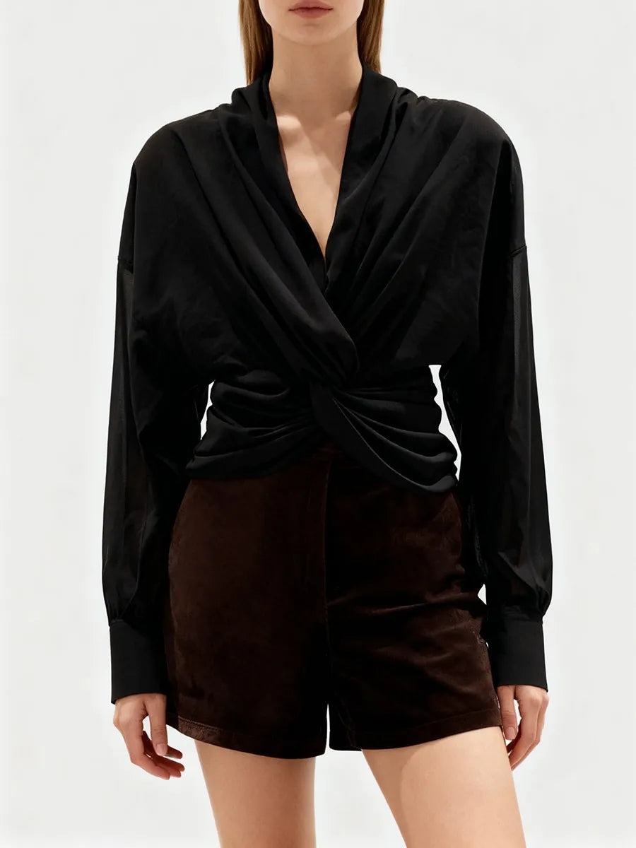 Styled look featuring the sculptural blouse paired with a fitted short for an elegant outfit