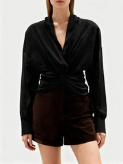 Styled look featuring the sculptural blouse paired with a fitted short for an elegant outfit