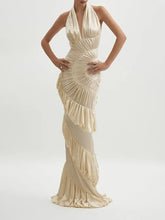 Floor-length pleated gown with halter neckline