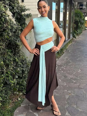 Side angle of a slim sheath maxi dress showing flowing panels