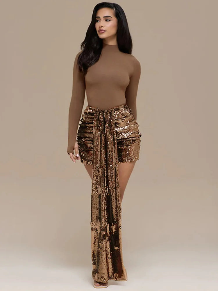 Full-length view of brown top paired with gold draped sequin mini skirt