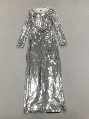Sleeve and torso detail showing dense silver sequins and smooth fit through the waist, capturing the dress’s sleek, elongated line.