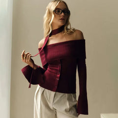 The front view of the top, showing the elegant scarf-shoulder design.