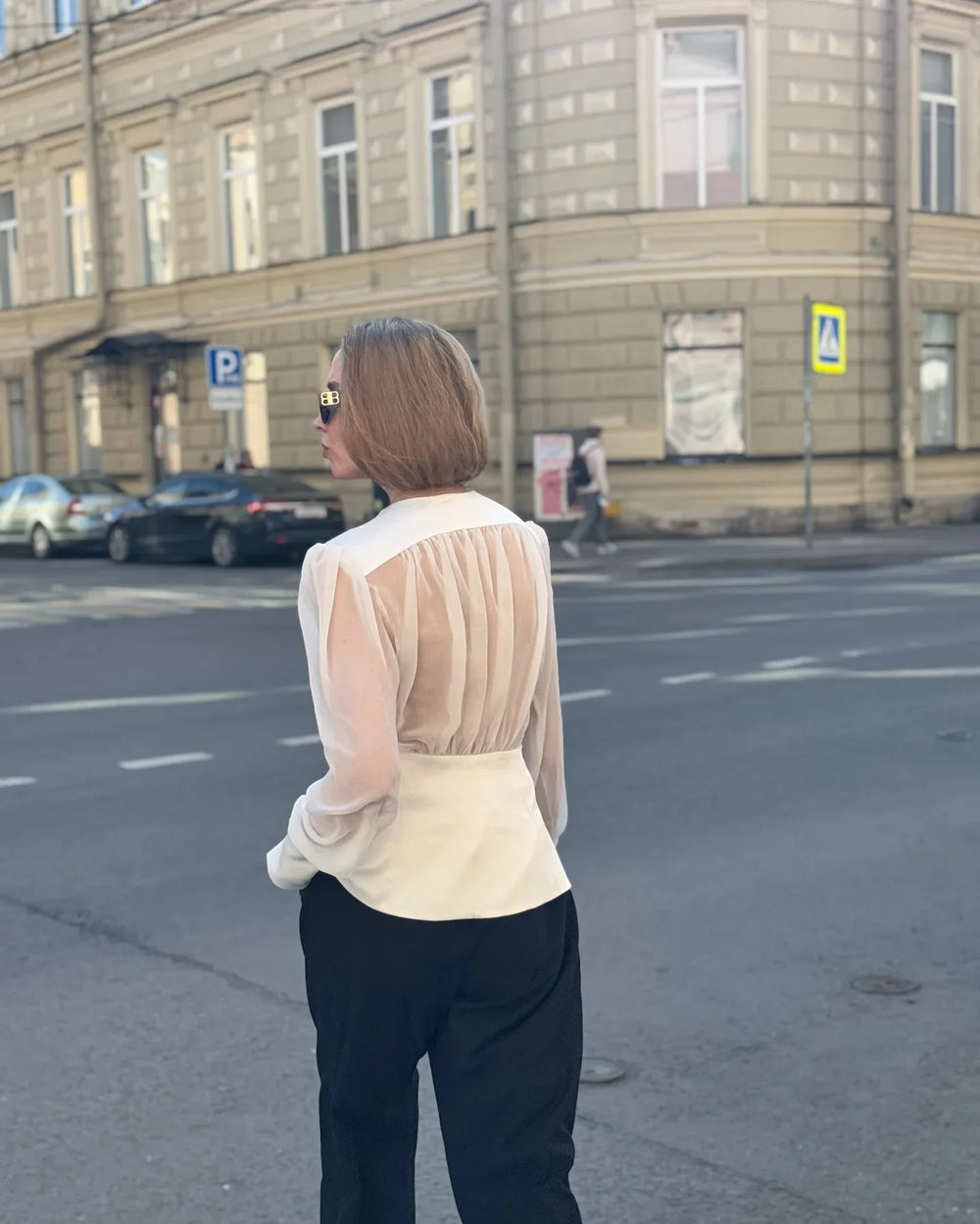 Close view of the neckline and fabric texture on a sheer-effect blouse