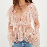 A close-up of the sheer fabric and texture of the top.