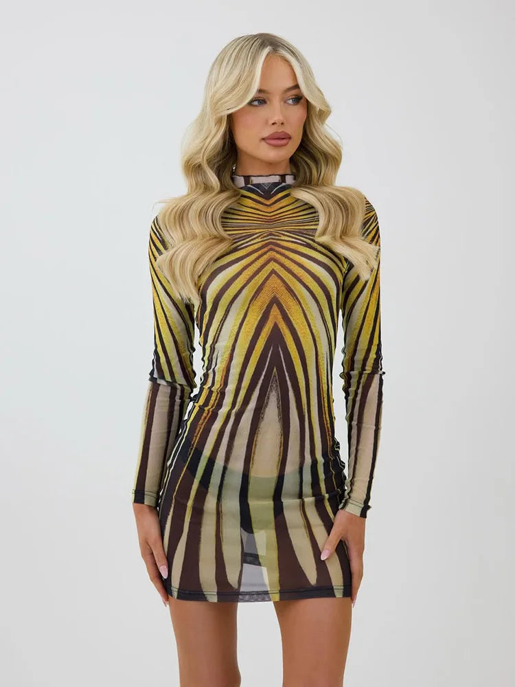 Woman wearing a sheer psychedelic print turtleneck mini dress on a plain background