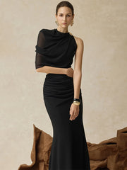 Close-up of the one-shoulder neckline and sheer sleeve, showing soft transparency and clean draping across the bodice.