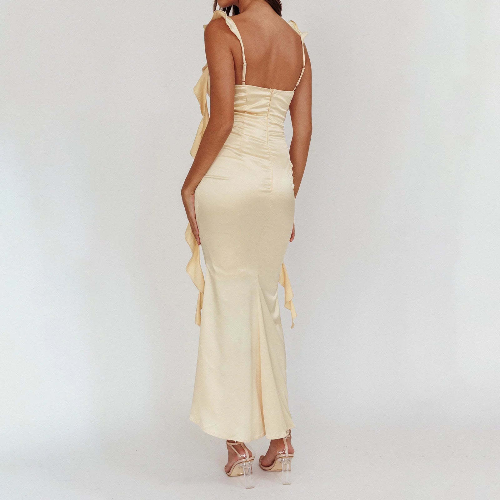 Side view of fitted yellow dress with adjustable straps and flowing hem