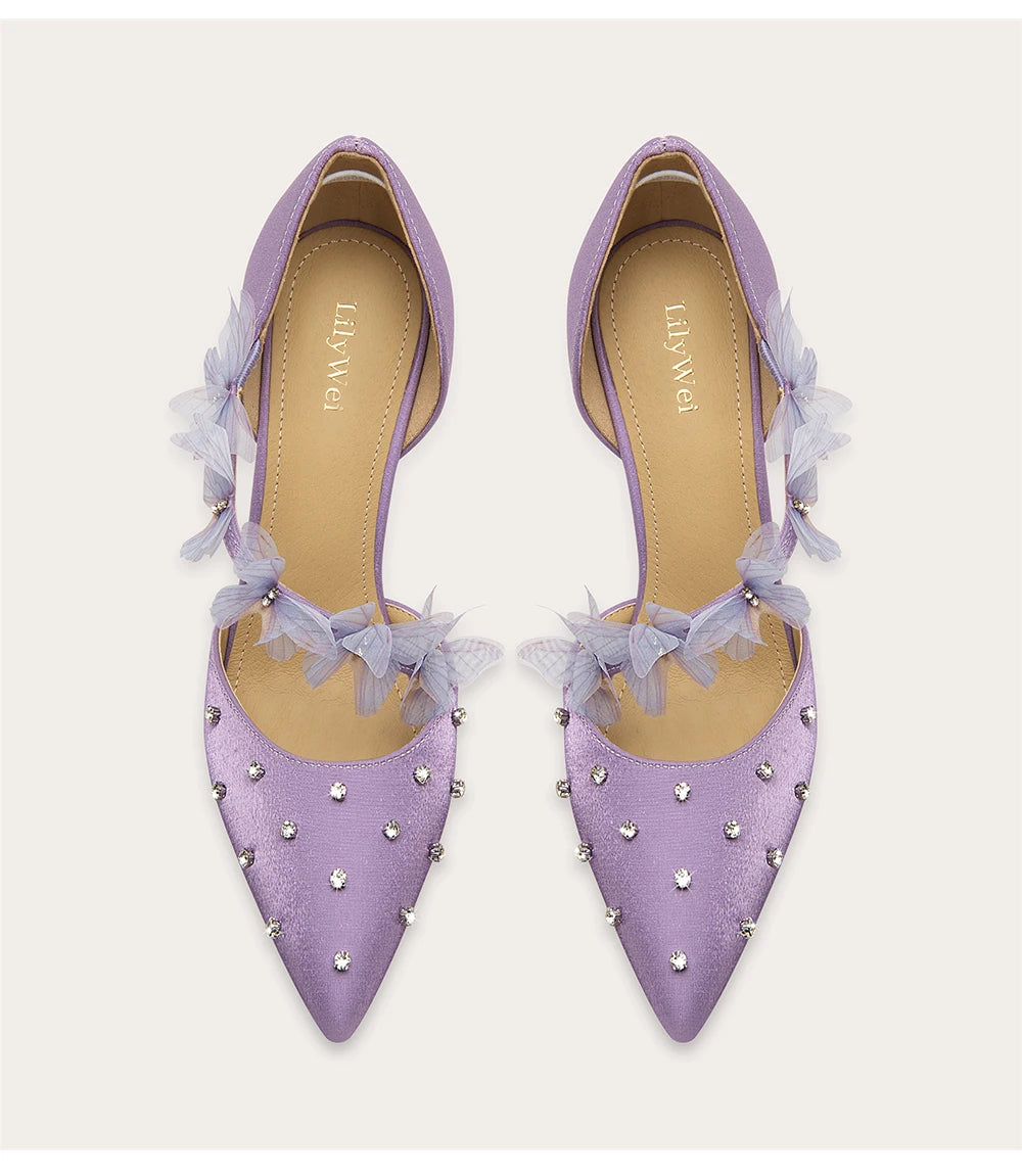 a silk sandal with a crystal and lace design and a thin heel.