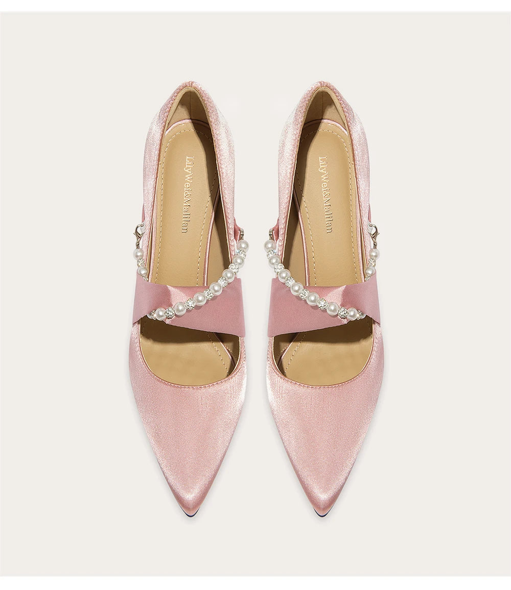 Close-up of silk wedding pumps with pearl and rhinestone details