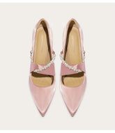 Close-up of silk wedding pumps with pearl and rhinestone details