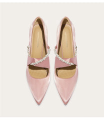 Close-up of silk wedding pumps with pearl and rhinestone details