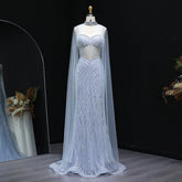 Beaded sweetheart mermaid gown displayed with a sheer cape overlay