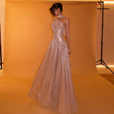 One-shoulder evening gown with pleated skirt and scarf detail