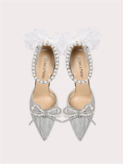 Silver pearl bow party sandals styled for weddings and glamour events