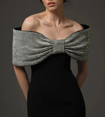 Close-up of the silver-toned rhinestone bow detail across the neckline, highlighting texture and sparkle.