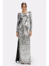 Full-length front view of a silver sequin sheath maxi dress with long sleeves and clean O-neckline on a studio background.