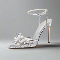 Silver mesh stiletto sandal with sequin and crystal bow designed for bridal events on a white background