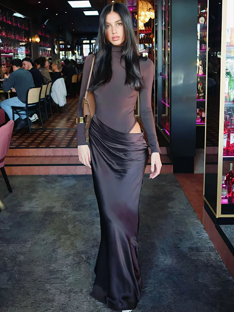 Woman in a bodycon evening dress styled for upscale fall parties, standing in a bar setting