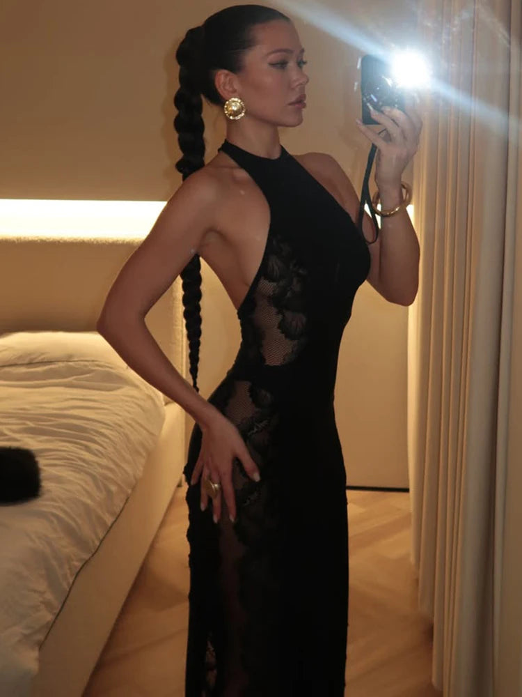 Full-length studio shot showing the slim fit and floor-length hem of the black halter maxi with lace detailing.