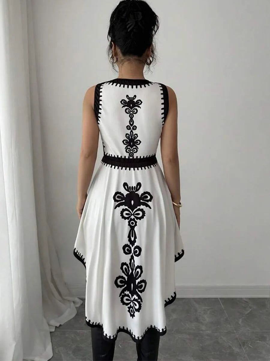 Sleeveless dress with bold embroidery and dramatic high-low motion