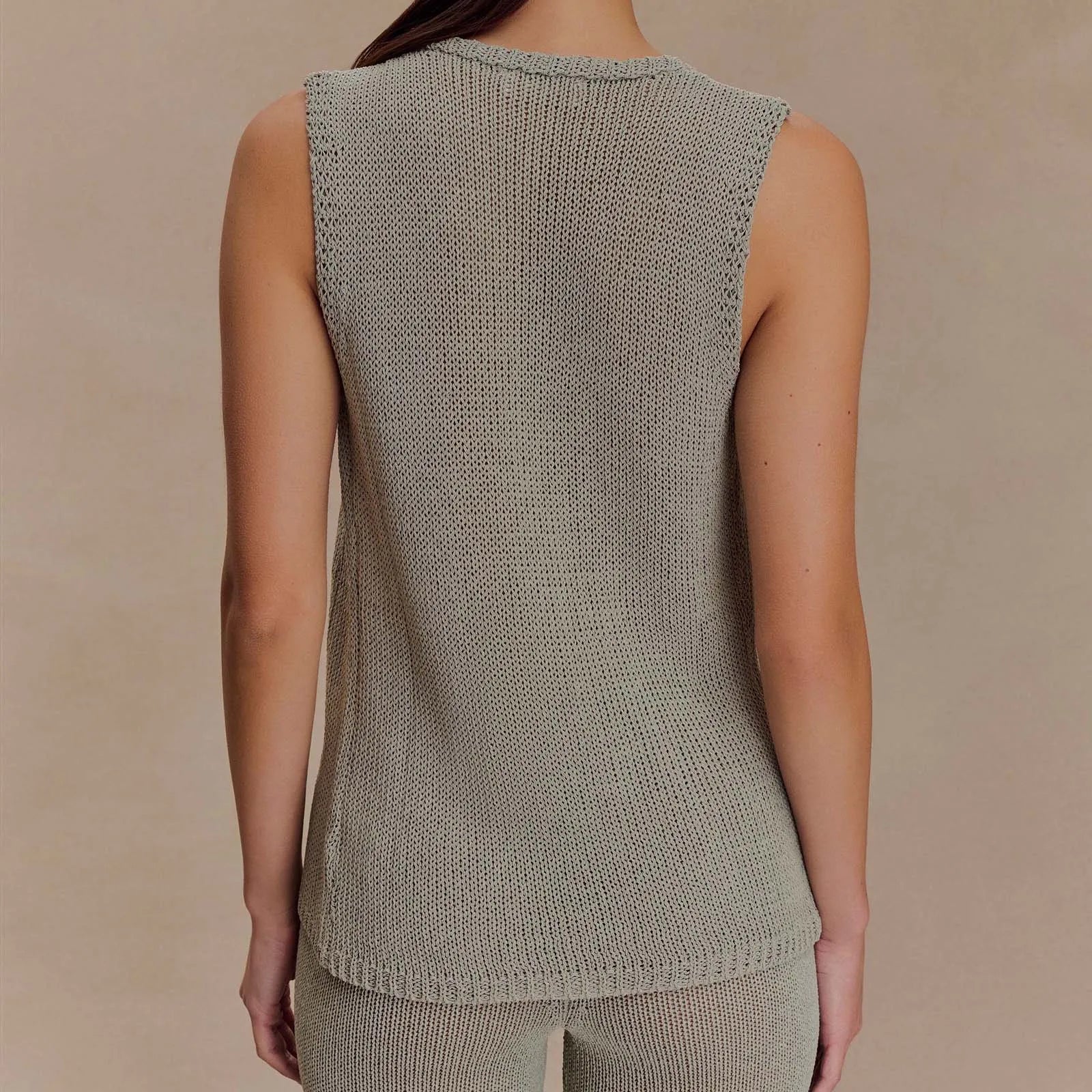 Sleeveless gray knit top shown as a closet staple for chic outfits