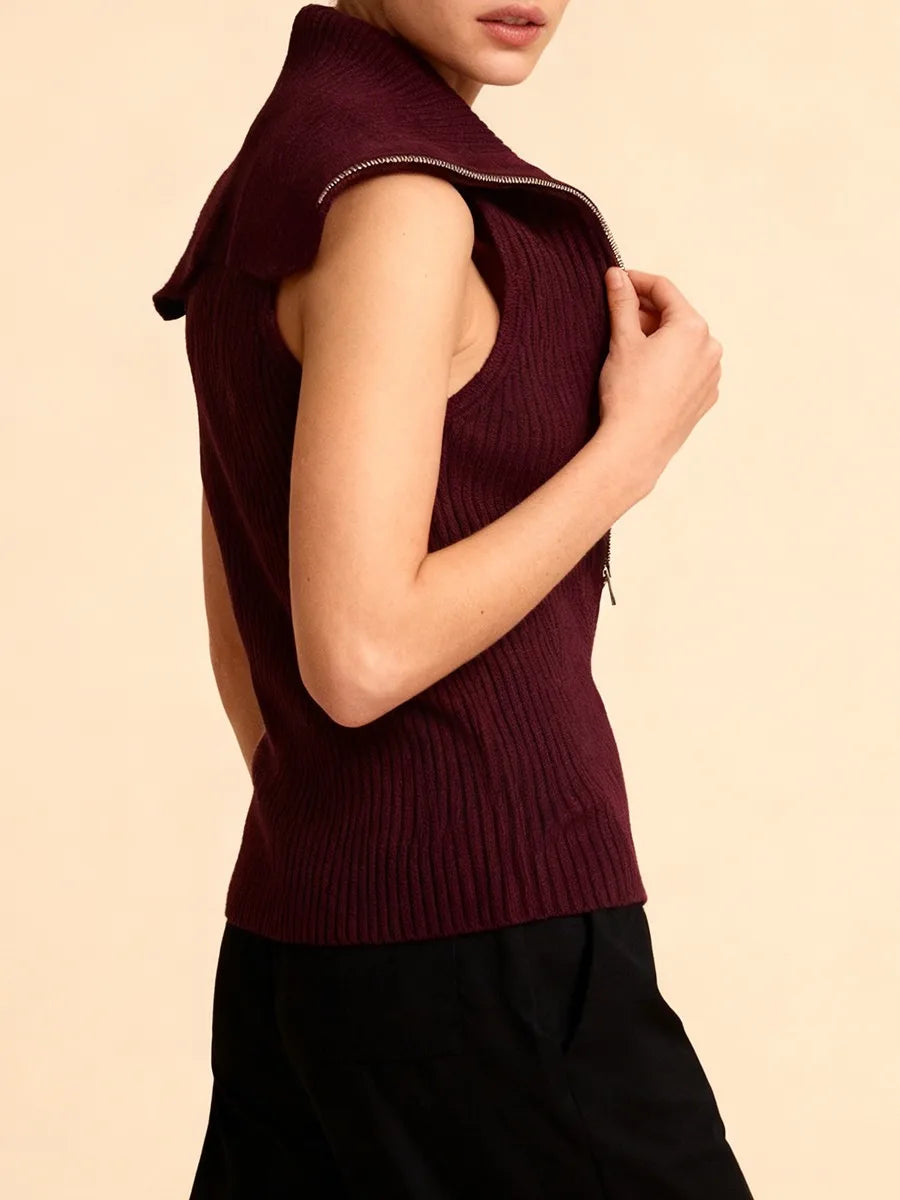 Close-up detail showing the zipper hardware and fine knit construction across the bodice