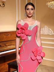 Woman wearing a sleeveless sheath party dress in pink with unique 3D flower detail in an elegant indoor setting