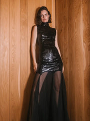 A full-length shot of a sleeveless sequin slim dress, highlighting its elegant silhouette.