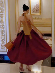 The dress showing the fit-and-flare silhouette and backless detail.
