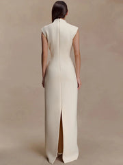 Straight-on angle emphasising the slim A-line shape and minimalist structure of the formal maxi dress.