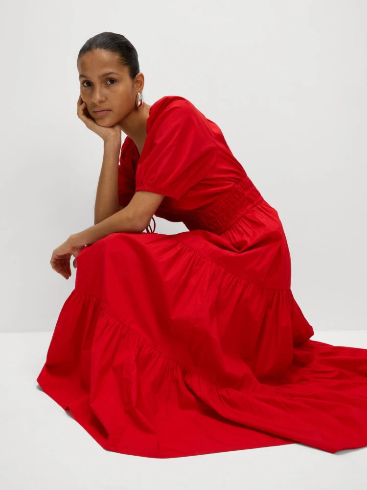 The slim fit of the dress highlights its flattering silhouette.