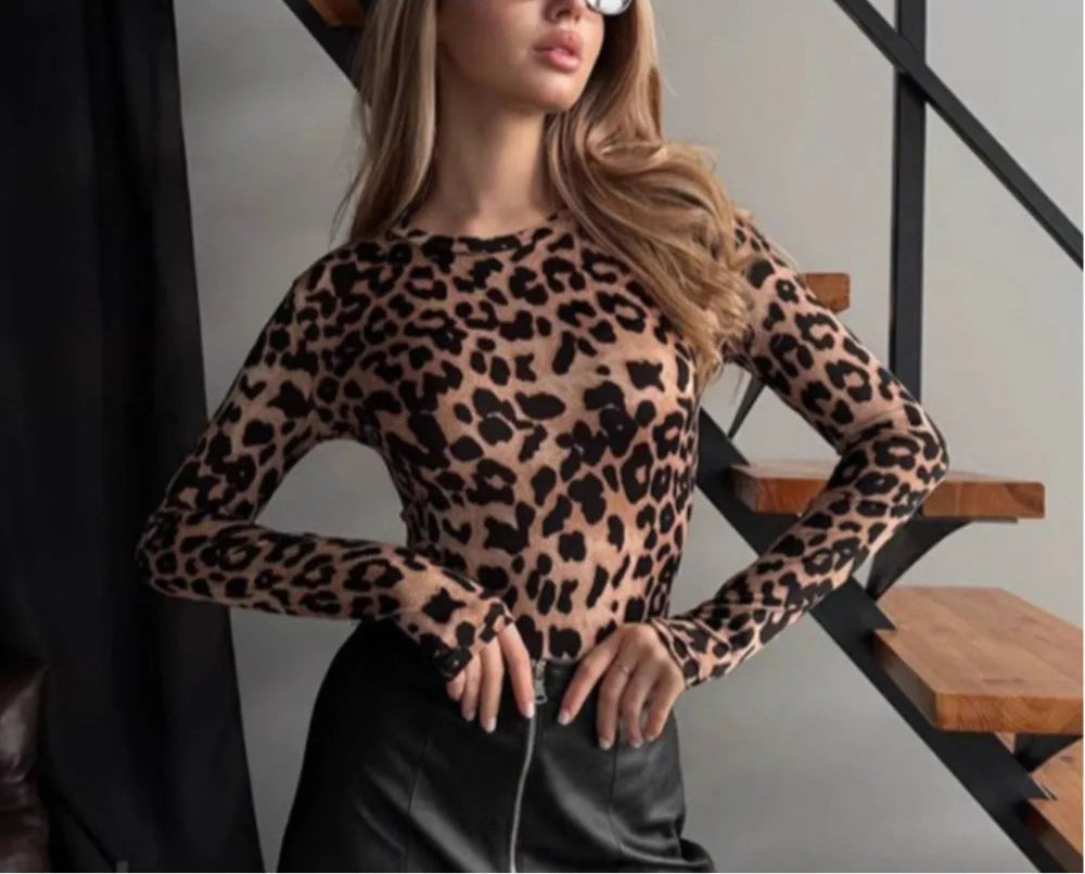 Person wearing a slim-fit jumpsuit with animal print in an indoor setting.